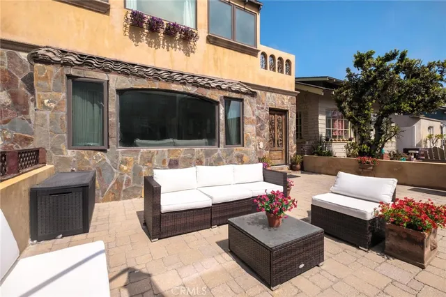 a view of a patio with couches and a flat screen tv