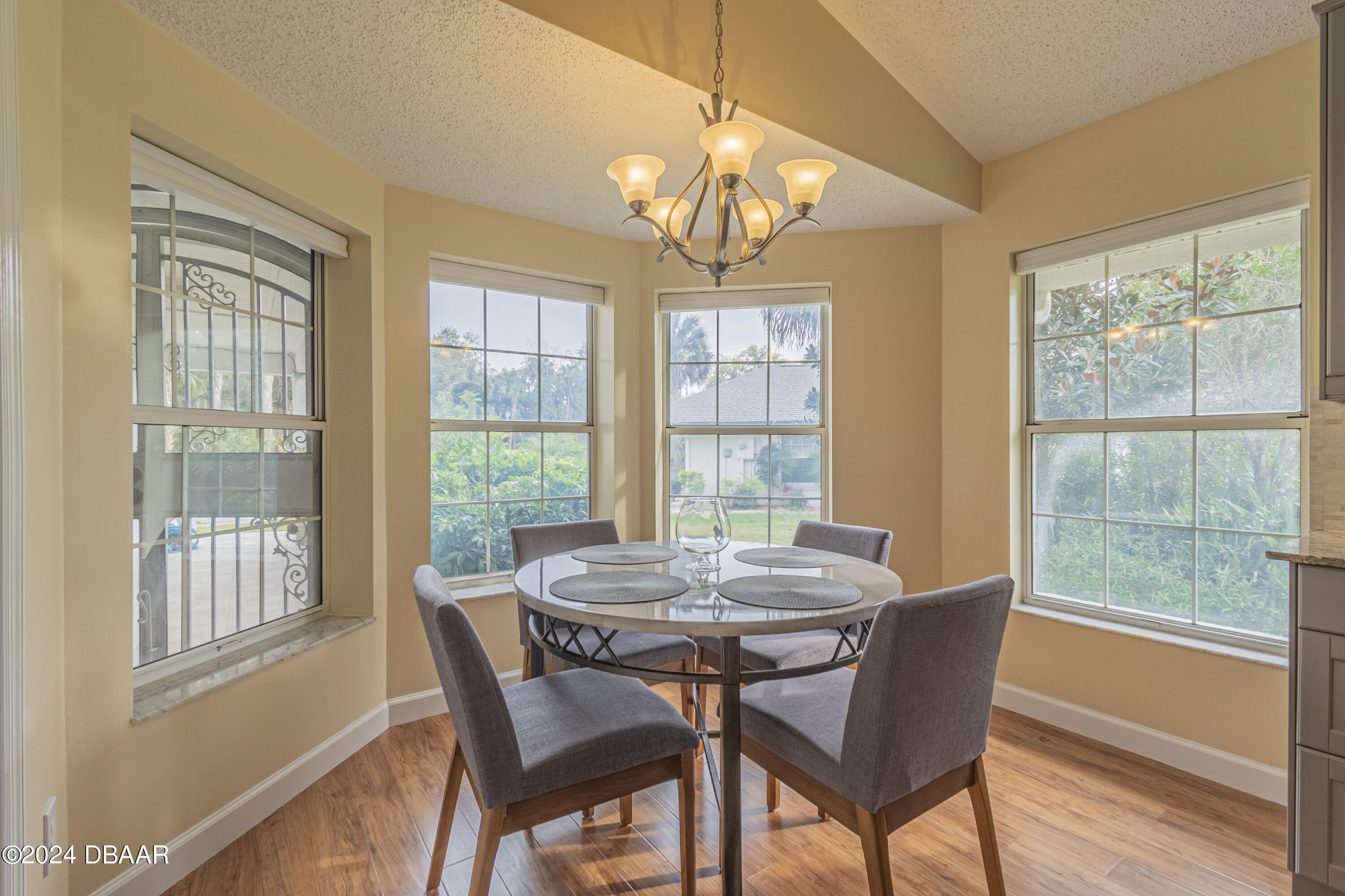 6236 Clover Bend Drive Port Orange, FL 32127 - Photo 16 of 73 a view of a dining room with furniture a chandelier and wooden floor