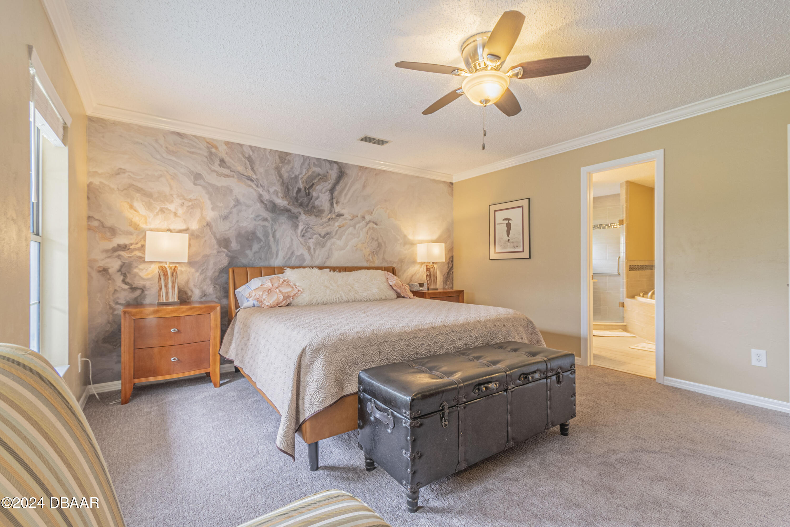 6236 Clover Bend Drive Port Orange, FL 32127 - Photo 24 of 73 a spacious bedroom with a bed and a chandelier