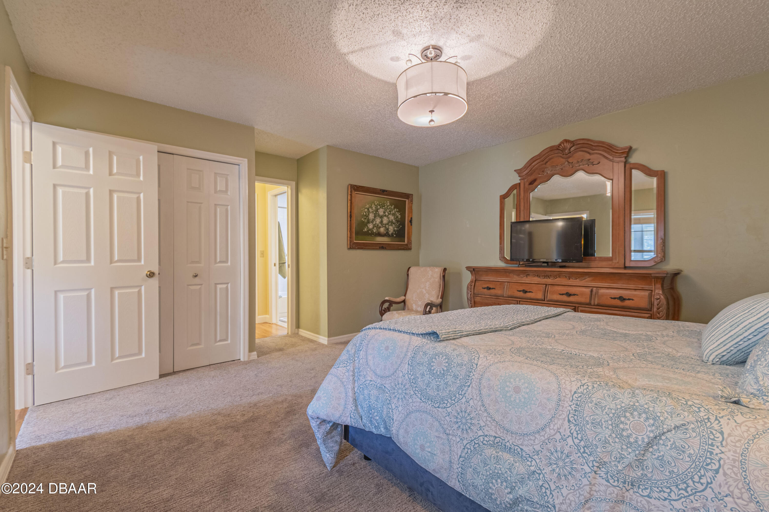 6236 Clover Bend Drive Port Orange, FL 32127 - Photo 30 of 73 a bedroom with a bed and a chandelier