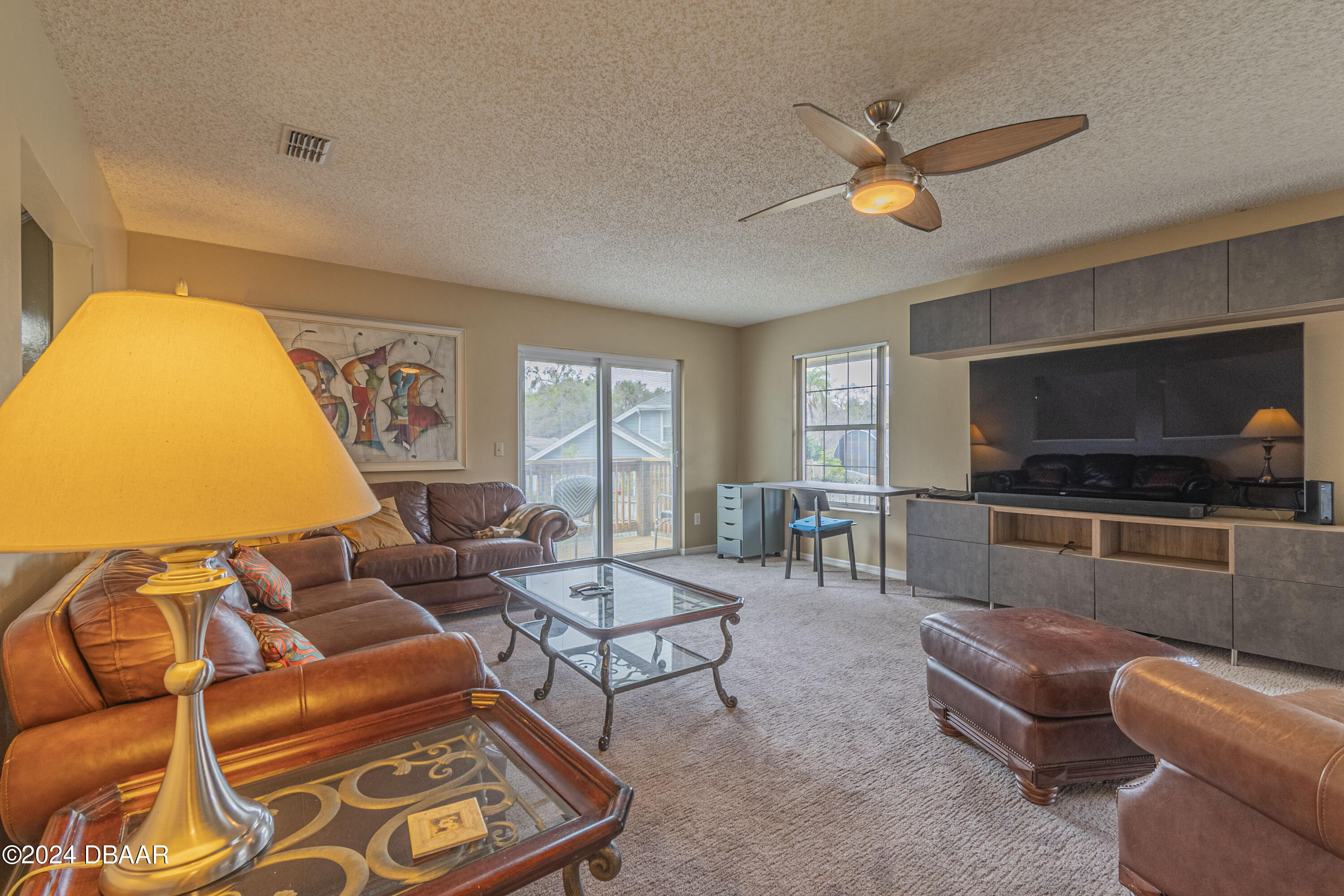 6236 Clover Bend Drive Port Orange, FL 32127 - Photo 36 of 73 a living room with furniture and a flat screen tv