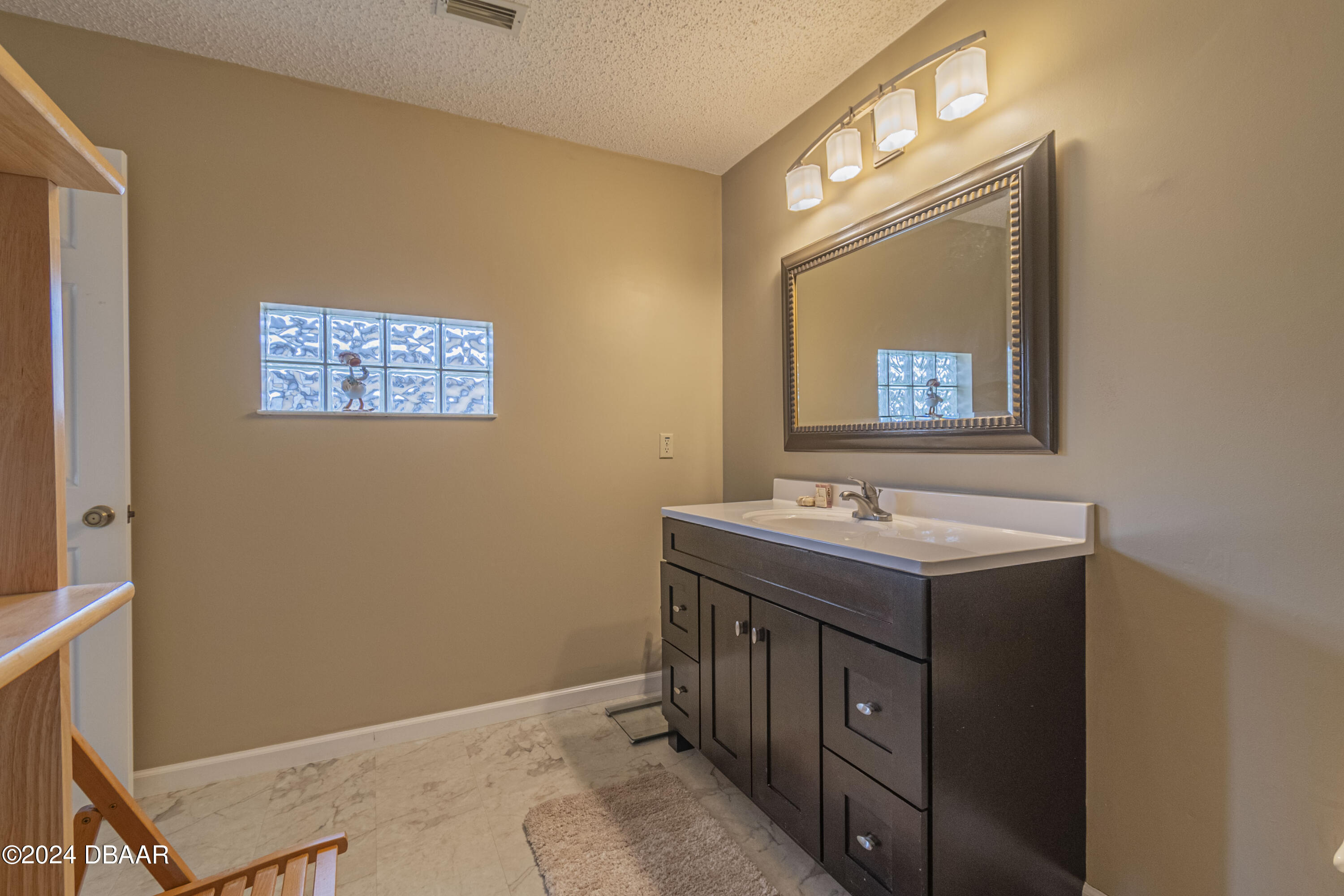 6236 Clover Bend Drive Port Orange, FL 32127 - Photo 43 of 73 a bathroom with a granite countertop sink and a mirror