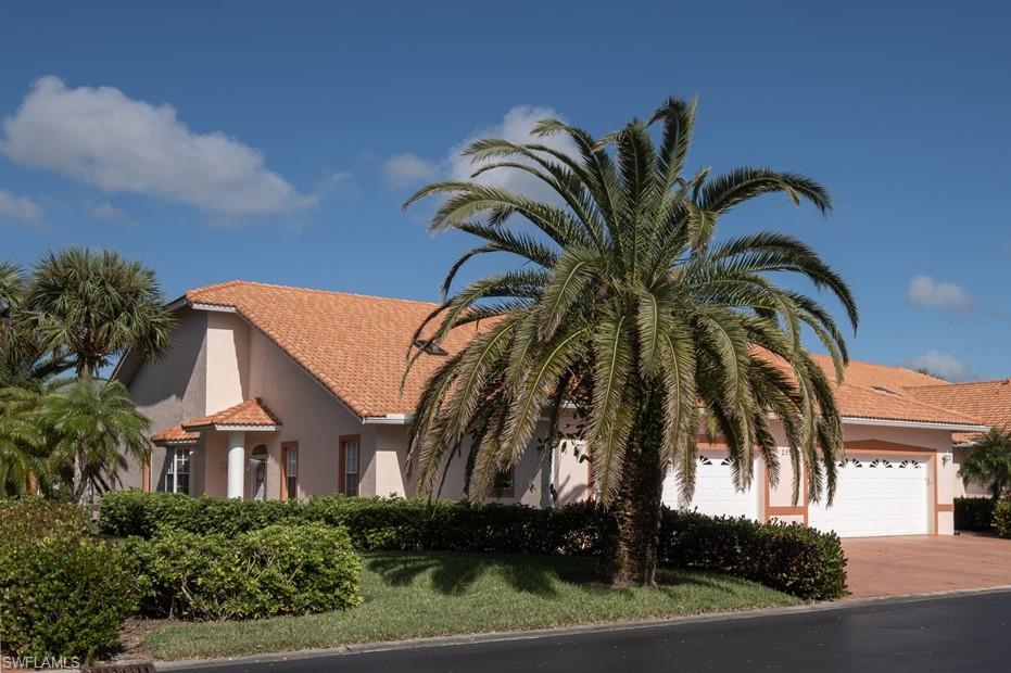 a view of a house with a palm tree