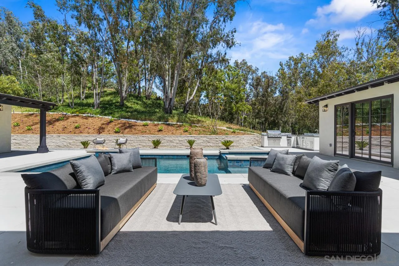 a view of patio with couches and a fire pit