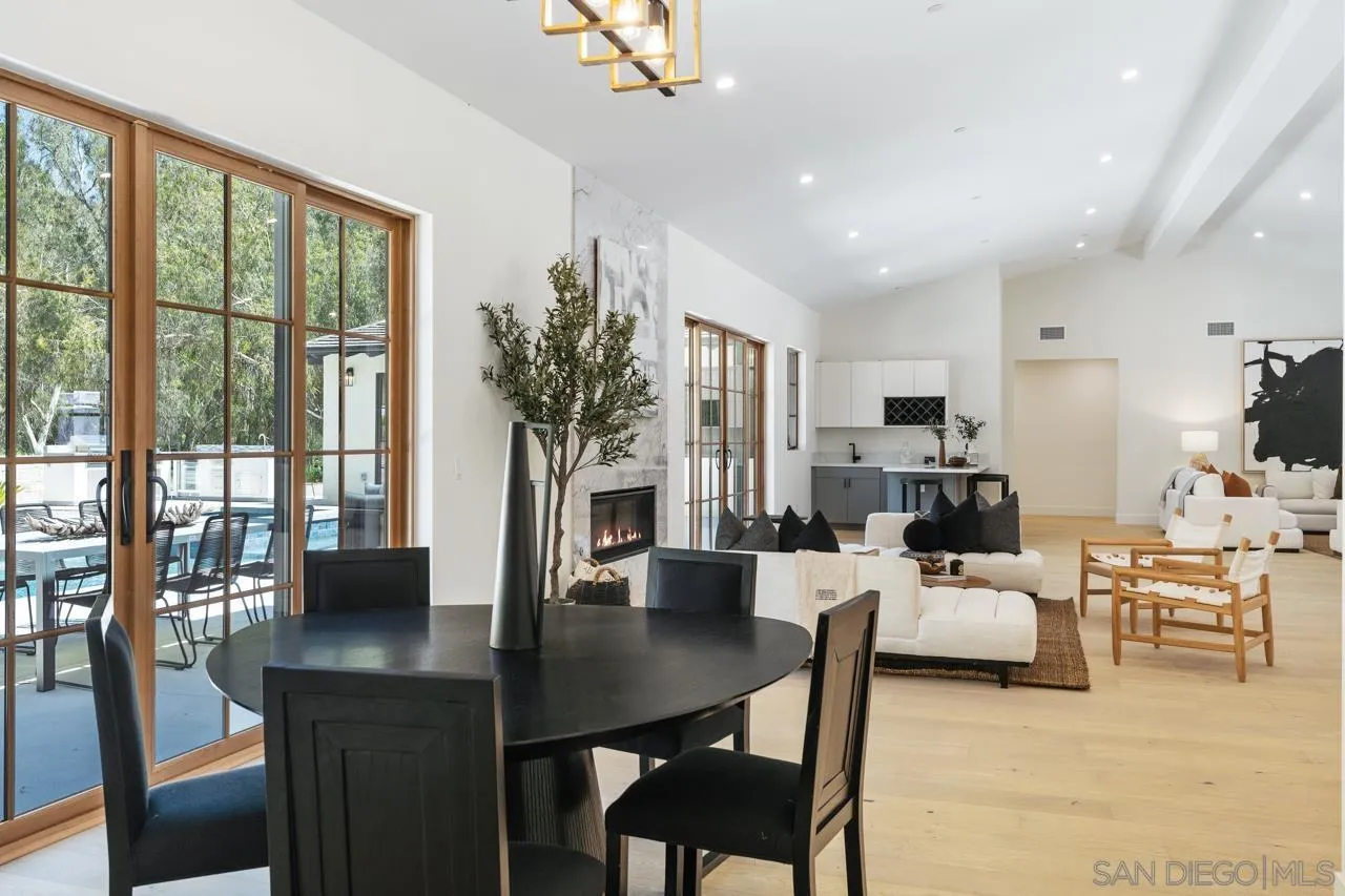 15245 El Camino Real Rancho Santa Fe, CA 92067 - Photo 18 of 41 a living room with furniture potted plant floor to ceiling windows and a flat screen tv
