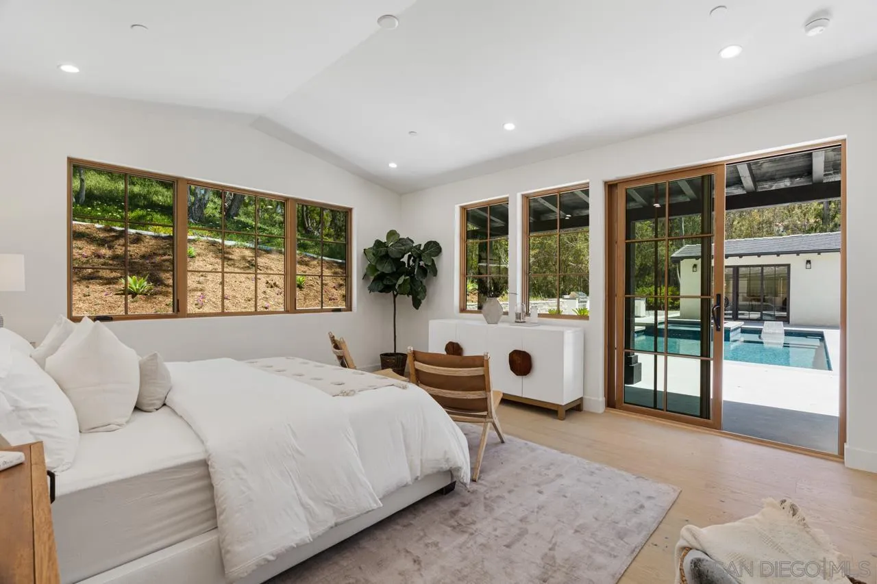15245 El Camino Real Rancho Santa Fe, CA 92067 - Photo 24 of 41 a bedroom with a large bed and a large window
