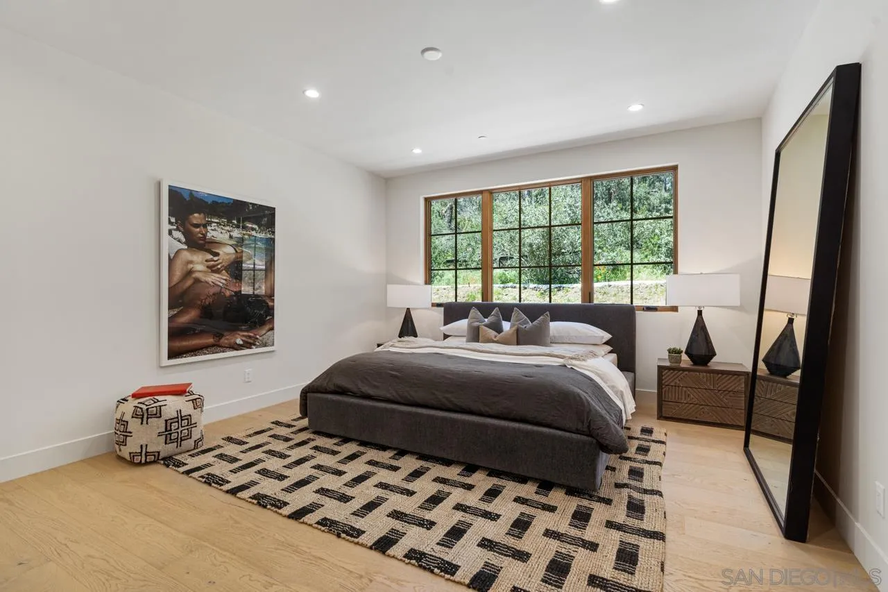 15245 El Camino Real Rancho Santa Fe, CA 92067 - Photo 27 of 41 a bedroom with a bed and a couch