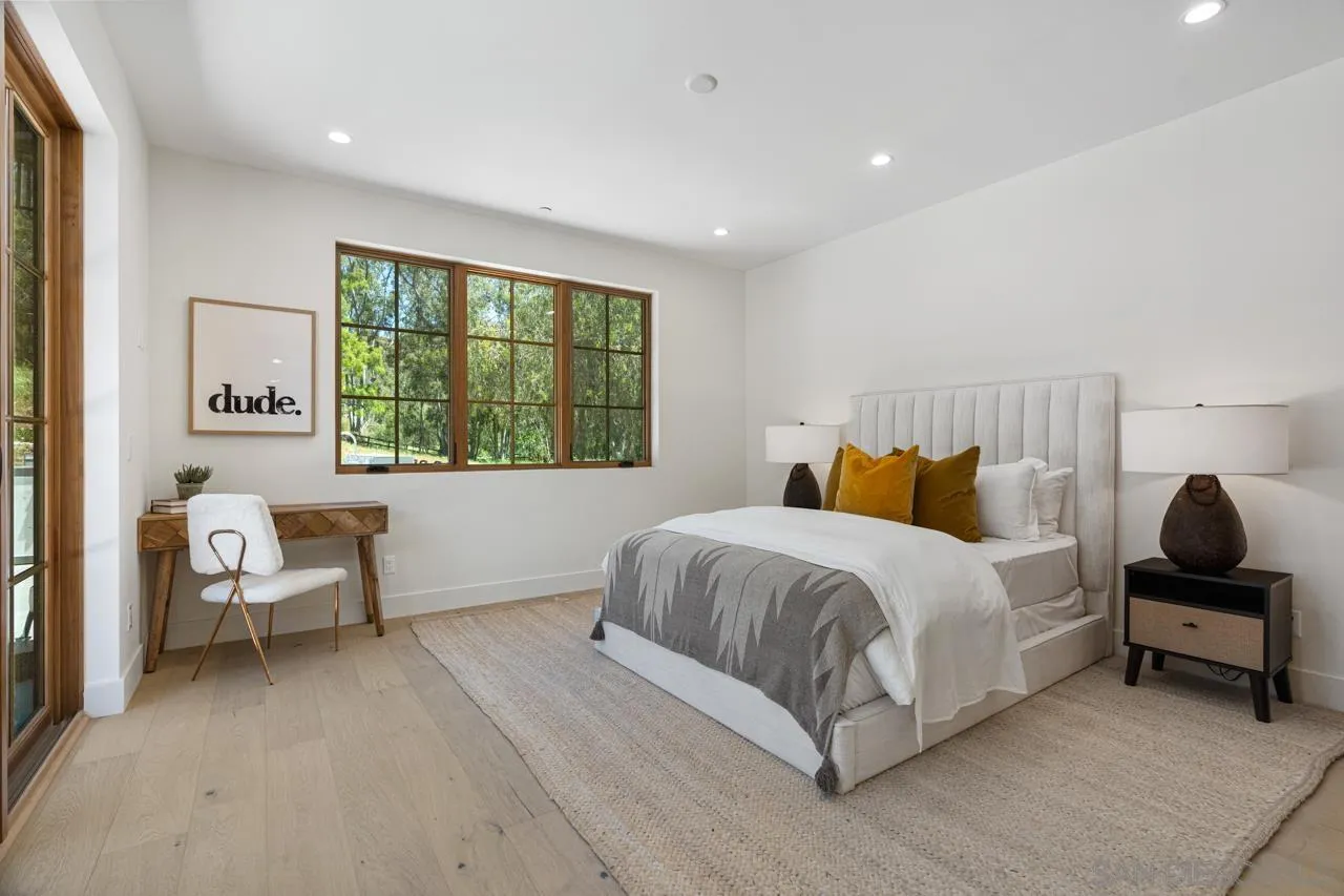 15245 El Camino Real Rancho Santa Fe, CA 92067 - Photo 29 of 41 a bedroom with a bed and a window