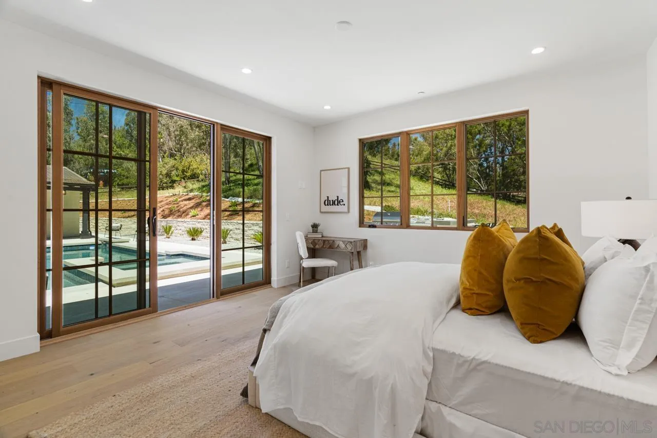 15245 El Camino Real Rancho Santa Fe, CA 92067 - Photo 30 of 41 a bedroom with a large bed and a large window