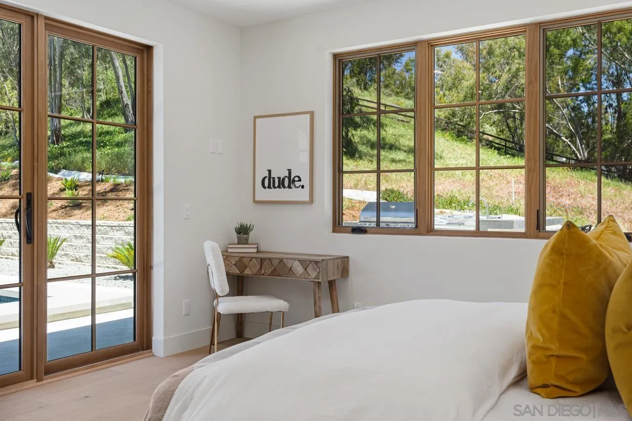15245 El Camino Real Rancho Santa Fe, CA 92067 - Photo 31 of 41 a bedroom with a bed and a large window