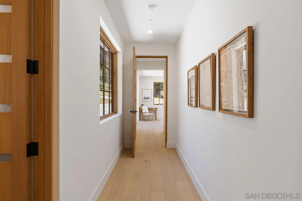 15245 El Camino Real Rancho Santa Fe, CA 92067 - Photo 32 of 41 a view of a hallway with wooden floor and staircase