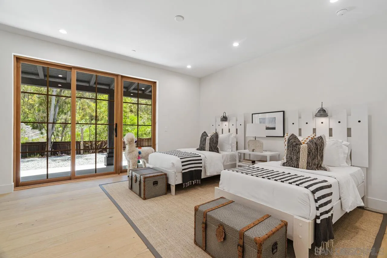 15245 El Camino Real Rancho Santa Fe, CA 92067 - Photo 33 of 41 a bedroom with a bed and a large window