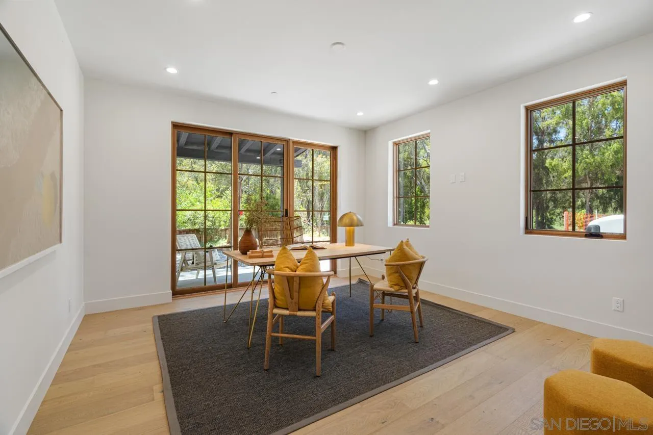 15245 El Camino Real Rancho Santa Fe, CA 92067 - Photo 36 of 41 a dining room with wooden floor and a window