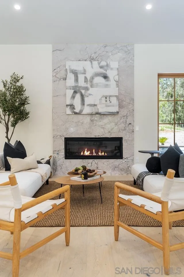 15245 El Camino Real Rancho Santa Fe, CA 92067 - Photo 6 of 41 a living room with furniture and a fireplace