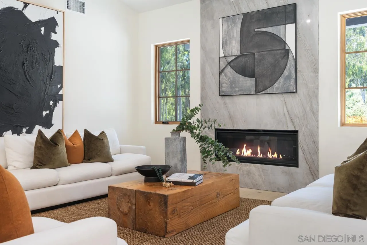 15245 El Camino Real Rancho Santa Fe, CA 92067 - Photo 10 of 41 a living room with furniture a window and a fireplace