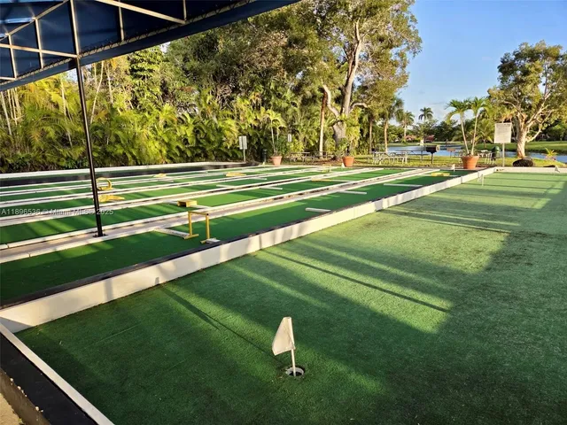 a room with furniture pool table and rug