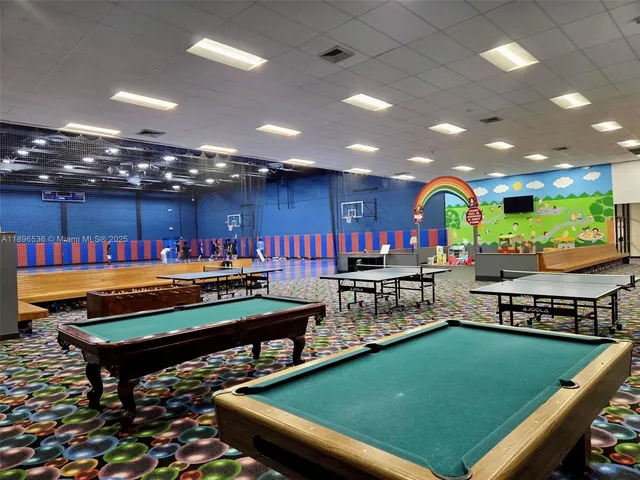 a view of swimming pool with outdoor seating and a floor to ceiling window