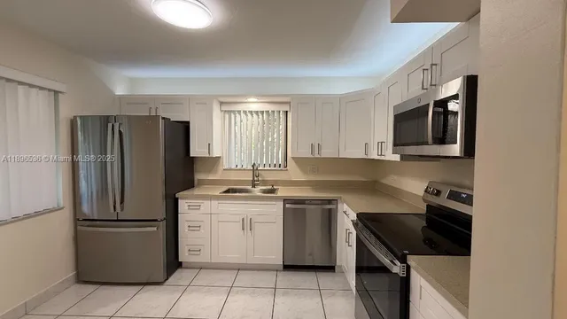 a kitchen with a sink a stove and refrigerator