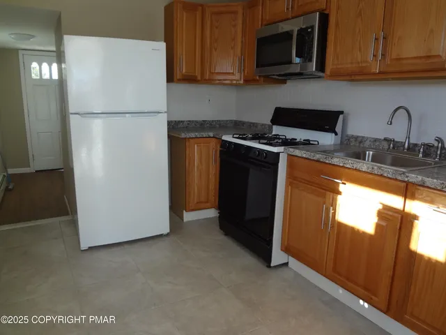 a white refrigerator freezer sitting in a kitchen