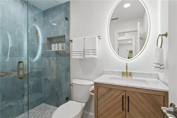 a bathroom with a sink a toilet and a mirror