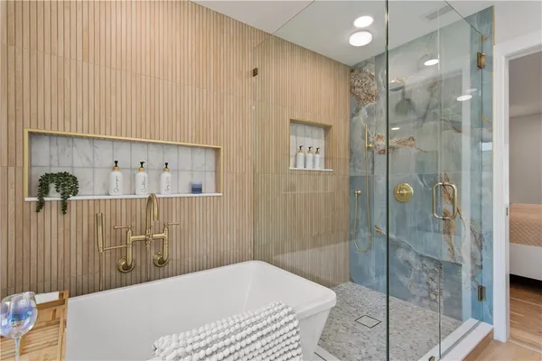 a bathroom with a bathtub and shower