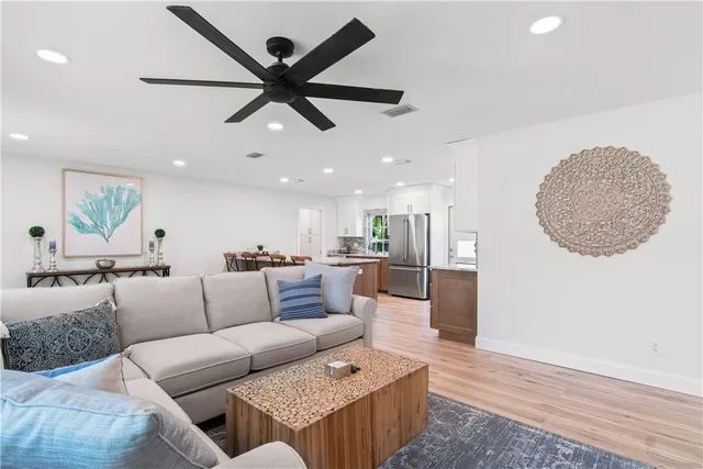 a living room with furniture and a wooden floor