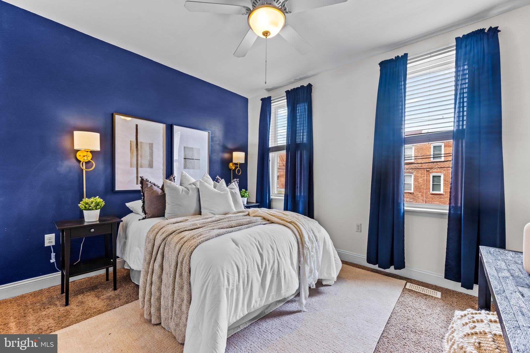 1243 Hull Street Baltimore, MD 21230 - Photo 25 of 39 a bedroom with a bed and lamp on table