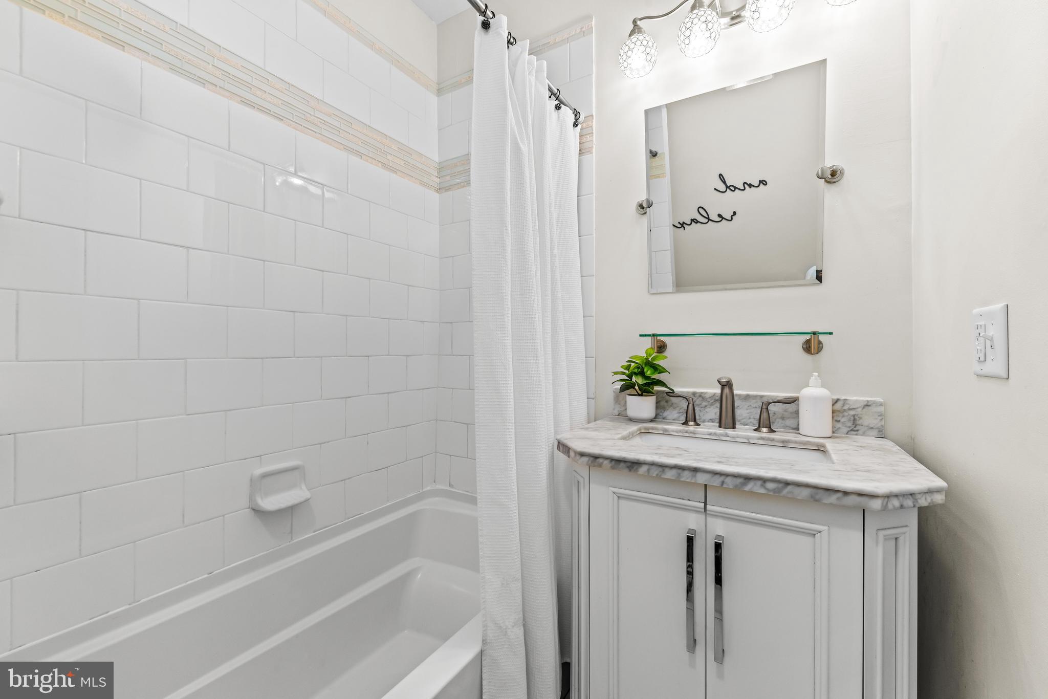 1243 Hull Street Baltimore, MD 21230 - Photo 28 of 39 a bathroom with a sink and a mirror