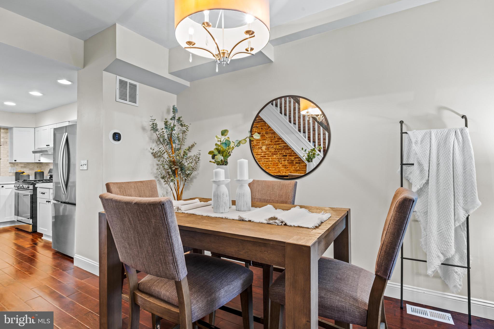 1243 Hull Street Baltimore, MD 21230 - Photo 7 of 39 a dining room with furniture a chandelier and wooden floor