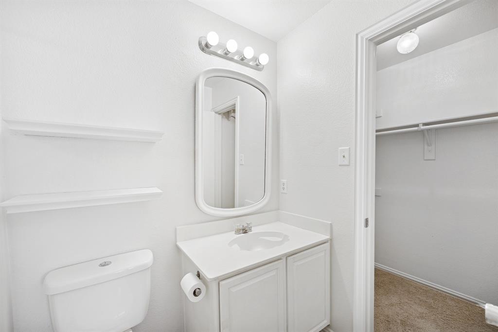 1747 Preston On The Lake Boulevard Little Elm, TX 75068 - Photo 11 of 23 a bathroom with a toilet a sink and mirror