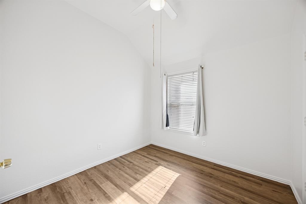 1747 Preston On The Lake Boulevard Little Elm, TX 75068 - Photo 14 of 23 an empty room with wooden floor cabinet and windows