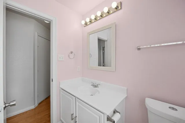 a bathroom with a sink a toilet and a mirror