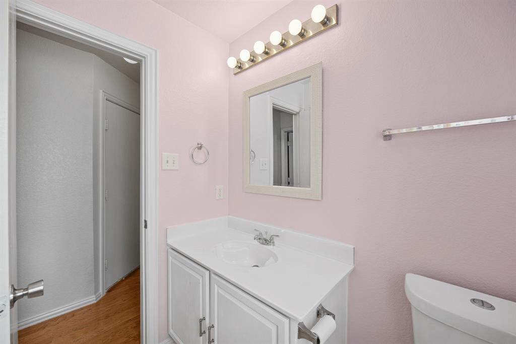 1747 Preston On The Lake Boulevard Little Elm, TX 75068 - Photo 18 of 23 a bathroom with a sink a toilet and a mirror