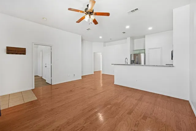 a view of a kitchen with a sink and a refrigerator