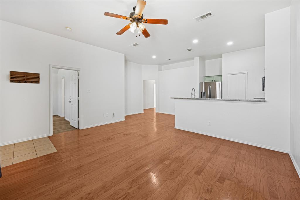 1747 Preston On The Lake Boulevard Little Elm, TX 75068 - Photo 5 of 23 a view of a kitchen with a sink and a refrigerator