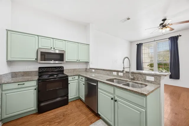 a kitchen with a sink stove and microwave