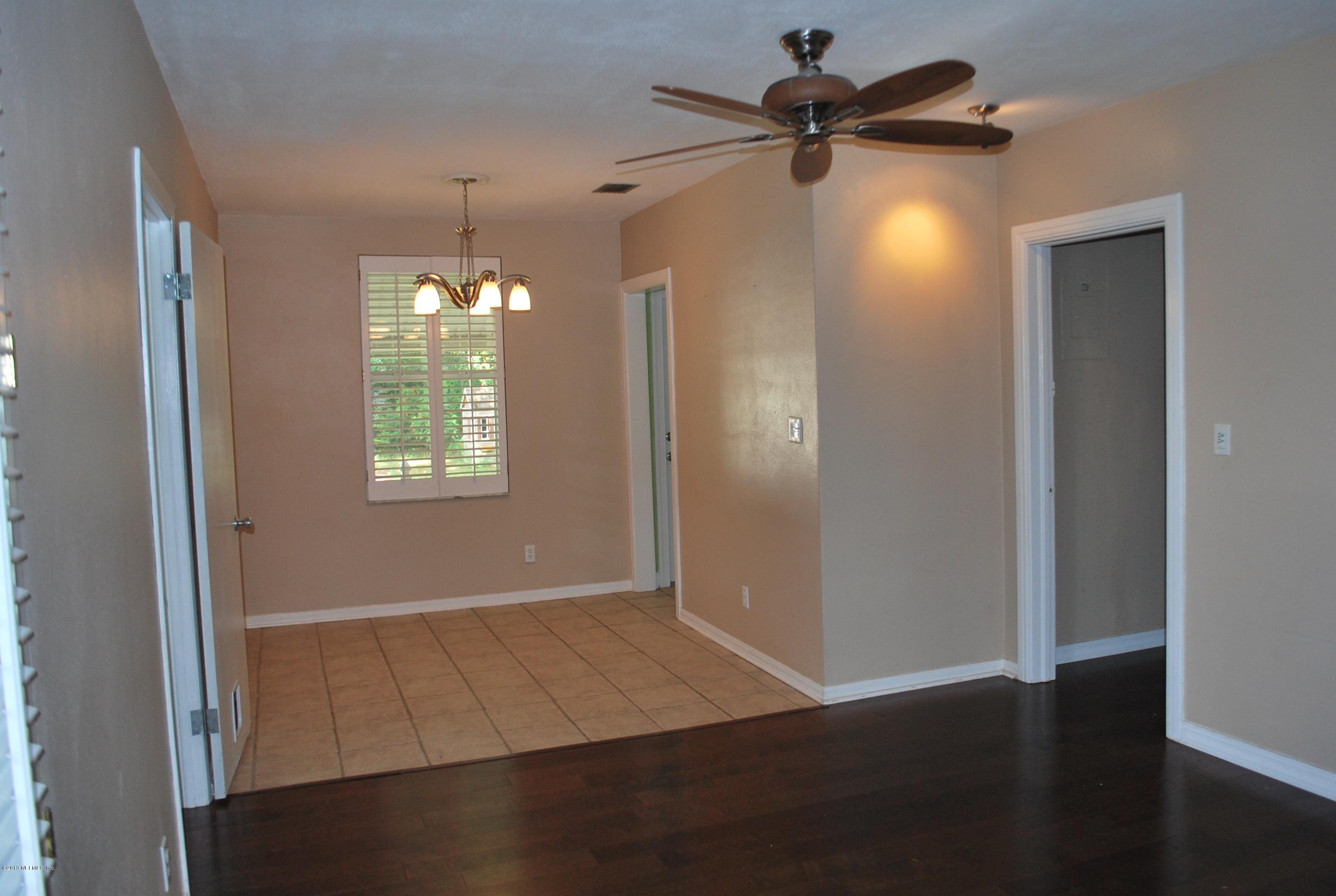 3917 Jean Street Jacksonville, FL 32205 - Photo 5 of 19 a view of an empty room with window and wooden floor