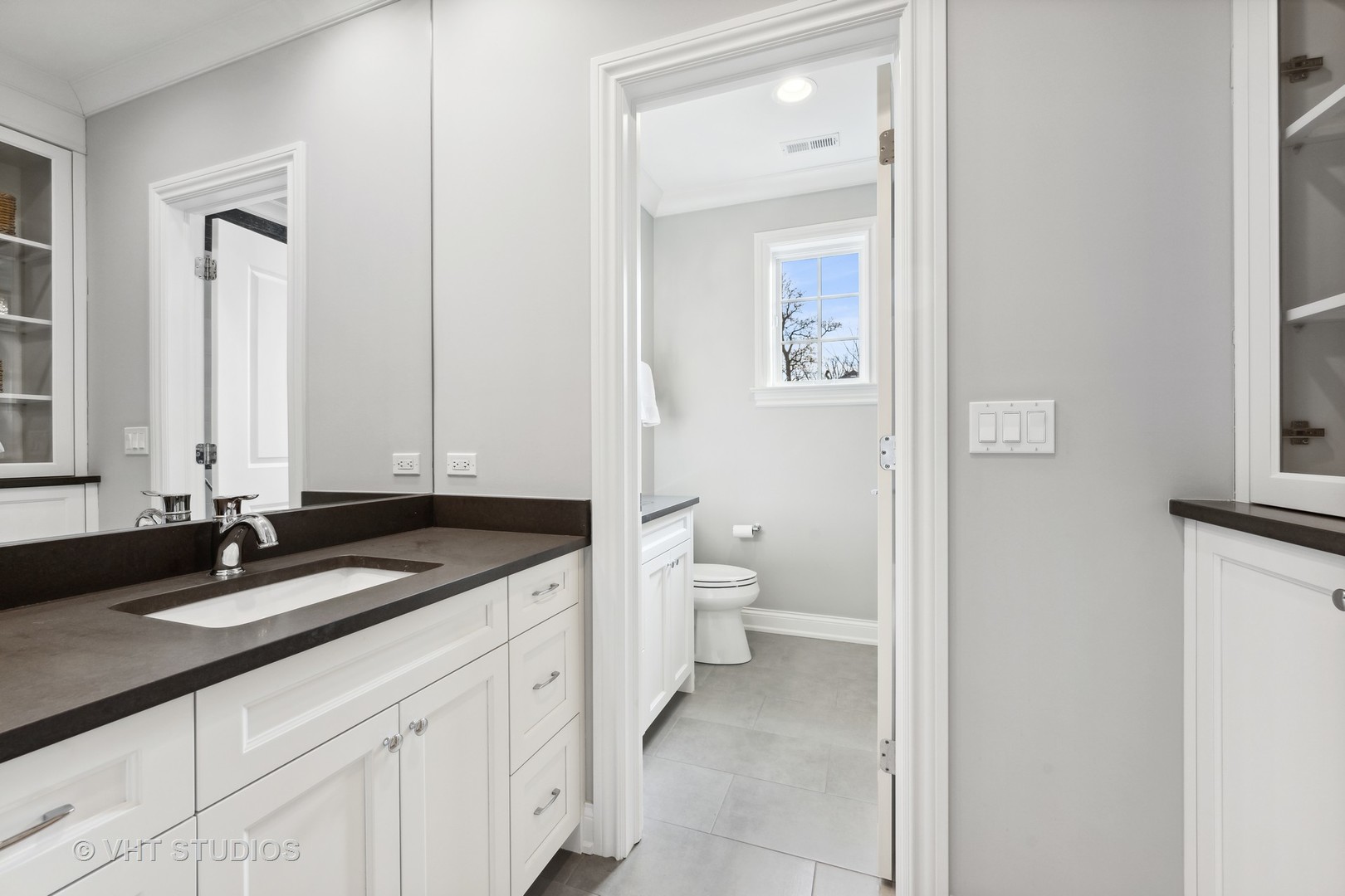814 17th Street Wilmette, IL 60091 - Photo 33 of 51 a bathroom with a granite countertop sink a toilet and a mirror