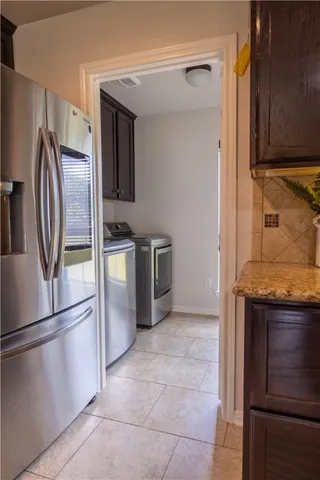 a kitchen with stainless steel appliances granite countertop a refrigerator and a stove