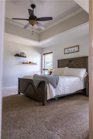 a bedroom with a bed and a ceiling fan