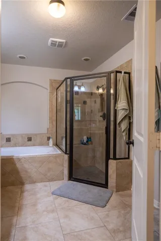 a bathroom with a tub and shower