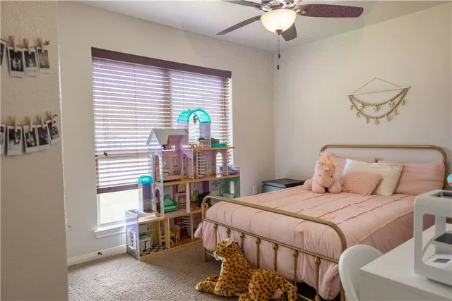 a bedroom with a bed a chandelier and a book shelf