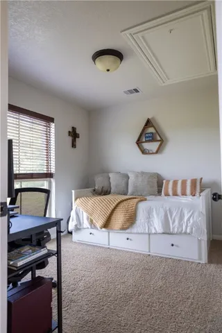a bedroom with a bed and a desk