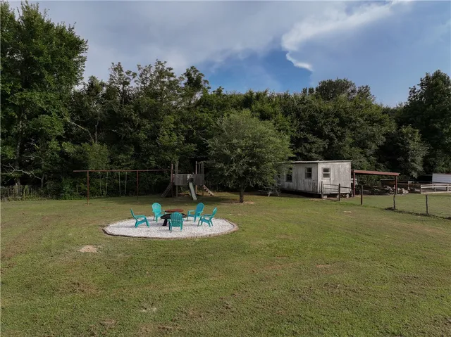 a view of a swimming pool and lounge chairs