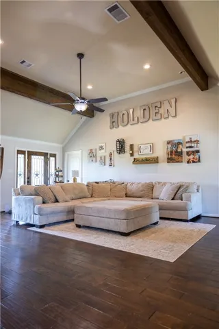a living room with furniture and a chandelier