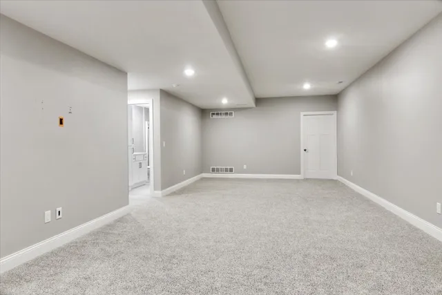 a bathroom with a sink mirror vanity and toilet
