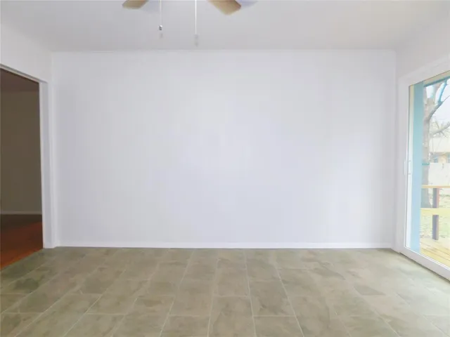 a view of an empty room and a window