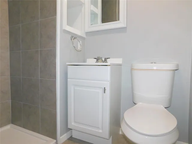 a white toilet sitting next to a bathroom sink