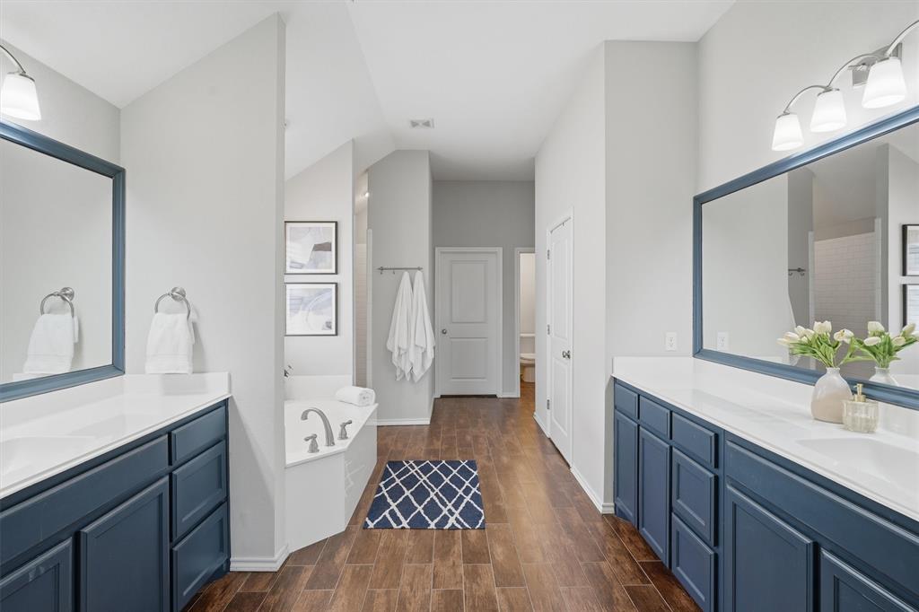 7224 Prestwick Terrace Benbrook, TX 76126 - Photo 13 of 26 Massive primary bathroom boasting extensive counter space, framed mirrors, and a private water closet. This bright and functional space includes a deep garden tub, chrome fixtures, and a seamless flow into the his/her walk-in closets.