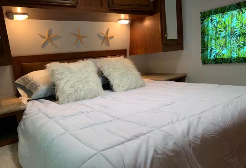 325 Calusa Street, Unit 121 Key Largo, FL 33037 - Photo 16 of 21 a large bed sitting in a bedroom next to a window